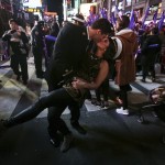 United States Navy Midshipman Kraft dips Cunningham as they pose for a photo in Times Square during New Year's Eve celebrations in Manhattan