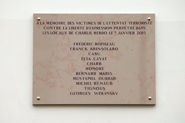 A commemorative plaque to pay tribute to the victims of the last year's January attacks is seen outside the former offices of French weekly satirical newspaper Charlie Hebdo during a ceremomy in Paris, France, January 5, 2016. France this week commemorates the victims of last year's Islamist militant attacks on satirical weekly Charlie Hebdo and a Jewish supermarket with eulogies, memorial plaques and another cartoon lampooning religion. REUTERS/Benoit Tessier