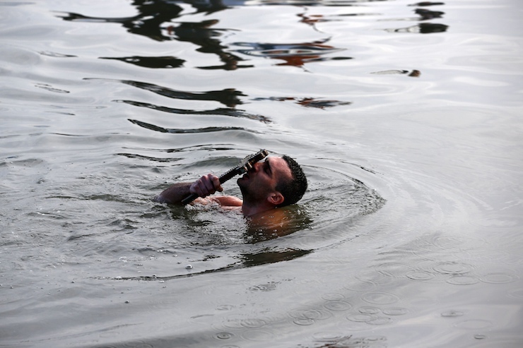 Greek Orthodox faithful Nikolas Solis, 28, a pilgrim from Agrinio of Greece, kisses a wooden crucifix in the Golden Horn in Istanbul January 6, 2016. Greek Orthodox faithful swam to retrieve the wooden crucifix thrown by Greek Orthodox Ecumenical Patriarch Bartholomew into the Golden Horn in Bosphorus during Epiphany Day celebrations. REUTERS/Murad Sezer