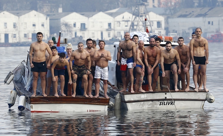 Greek Orthodox faithful wait for the Greek Orthodox Ecumenical Patriarch Bartholomew I (not pictured) to throw a wooden crucifix into the Golden Horn in Istanbul, Turkey, January 6, 2016. Greek Orthodox faithful swam to retrieve the wooden crucifix thrown by Greek Orthodox Ecumenical Patriarch Bartholomew I into the Golden Horn in Bosphorus during Epiphany Day celebrations. REUTERS/Murad Sezer