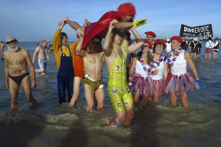 People wearing costumes participate in a traditional New Year's Day swim in Dunkirk