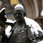 A statue of the late Pope John XXIII is covered by snow at the courtyard of the St. Antuan Catholic church in central Istanbul