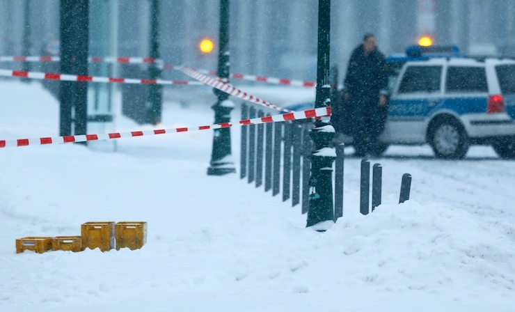 A police car is parked behind suspicious yellow postal crates near the chancellery in Berlin, Germany on January 6, 2016. The office of Chancellor Angela Merkel has been sealed off due to a suspicious package, a police spokesman said on Wednesday. "We are investigating a suspicious package," a spokesman for Germany's Federal Police told Reuters. A Reuters eyewitness said there were four plastic yellow postal crates in front of the cordoned off area. REUTERS/Hannibal Hanschke