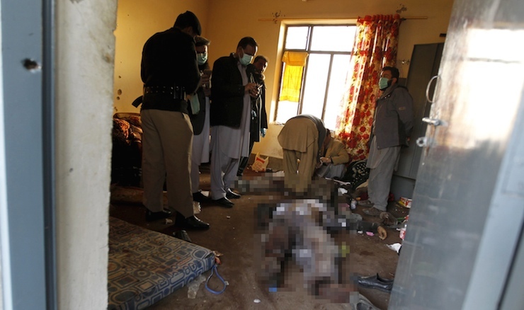 Forensic experts examine the bodies of attackers in a dorm room at Bacha Khan University, where a militant attack took place, in Charsadda