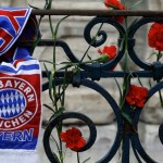 A Bayern Munich football club scarf is tied to a railing next to flowers at the Obelisk of Theodosius at Sultanahmet square in Istanbul