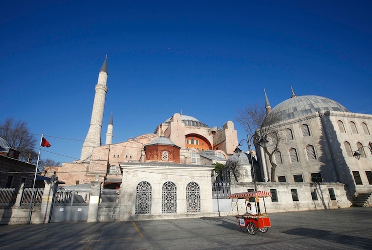 A food vendor stands in a deserted square in front of the New Mosque following an explosion in Istanbul