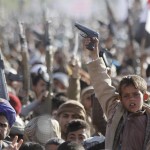 A boy shouts slogans as he raises a gun during a rally against U.S. support to Saudi-led air strikes, in Yemen's capital Sanaa
