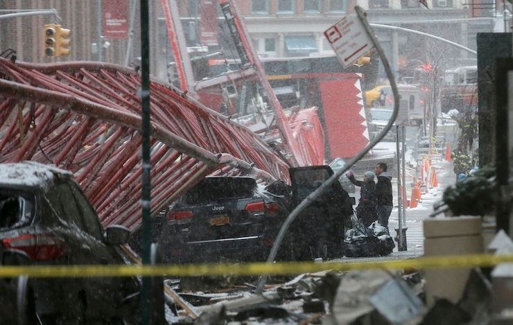 Emergency crews survey a massive construction crane collapse on a street in downtown Manhattan in New York