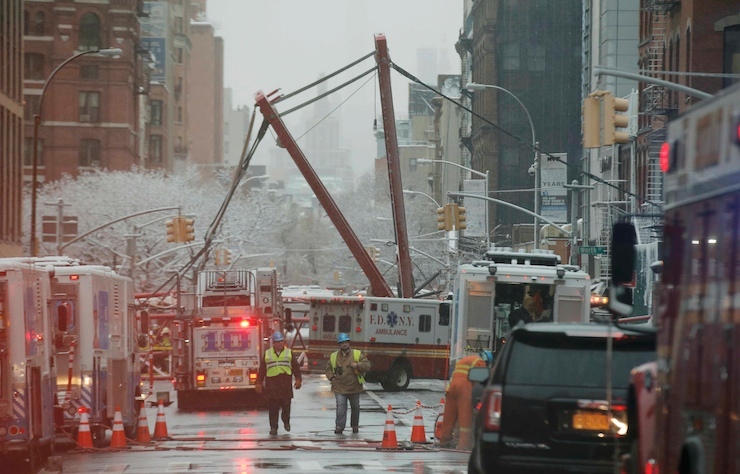 Emergency crews survey a massive construction crane collapse on a street in downtown Manhattan