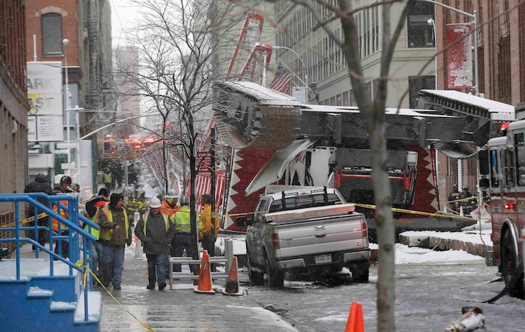 Emergency crews survey a massive construction crane collapse on a street in downtown Manhattan