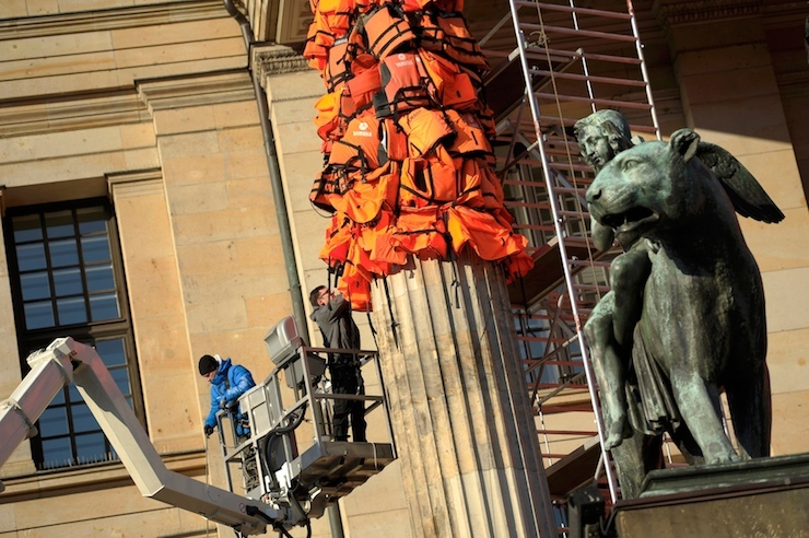 Workers bulid up an instalation by Chinese artist and free-speech advocate Ai Weiwei with life jackets left by migrants on Greek beaches on columns at the Schauspielhaus concert hall during the 66th Berlinale International Film Festival in Berlin, Germany February 13, 2016. Ai Weiwei used about 14,000 discarded life jackets, which he obtained from authorities from the Greek island of Lesbos for this memorial project. REUTERS/Stefanie Loos FOR EDITORIAL USE ONLY. NOT FOR SALE FOR MARKETING OR ADVERTISING CAMPAIGNS.