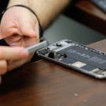 A worker checks an iPhone in a repair store in New York