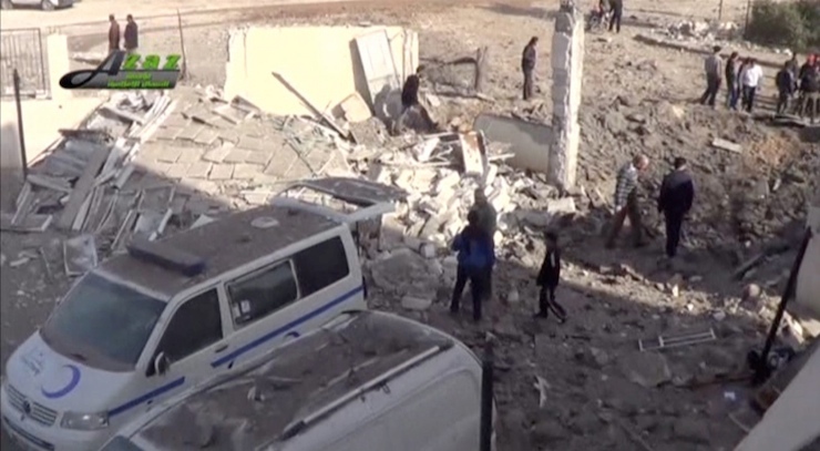 Still image taken from video shows people gathering near what is said to be a hospital damaged by missile attacks in Azaz