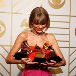 Taylor Swift poses with her awards during the 58th Grammy Awards in Los Angeles