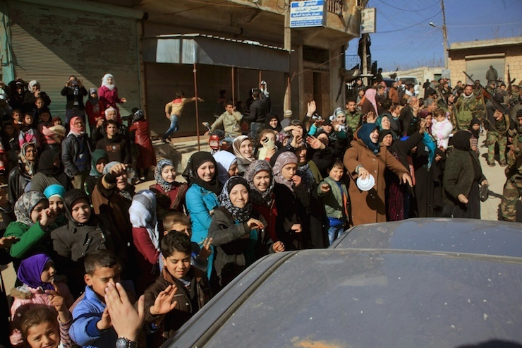 Residents of Nubul and al-Zahraa, along with forces loyal to Syria's President Bashar al-Assad, celebrate after the siege of their towns was broken, northern Aleppo countryside