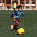 Five year-old Murtaza Ahmadi wears Barcelona's star Lionel Messi shirt made of a plastic bag as he plays soccer at the Afghan Football Federation headquarters in Kabul
