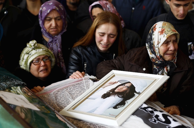 Relatives of Destina Peri Parlak, one of the victims of Sunday's suicide bomb attack, mourns next to her coffin during a funeral ceremony in Ankara, Turkey March 15, 2016. REUTERS/Umit Bektas