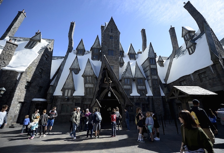 Guests walk through Hogsmeade Village during a soft opening and media tour of "The Wizarding World of Harry Potter" theme park at the Universal Studios Hollywood in Los Angeles