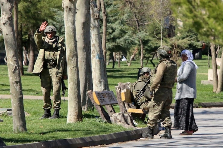 Turkish soldiers stand at a park in Baglar district, which is partially under curfew, in the Kurdish-dominated southeastern city of Diyarbakir