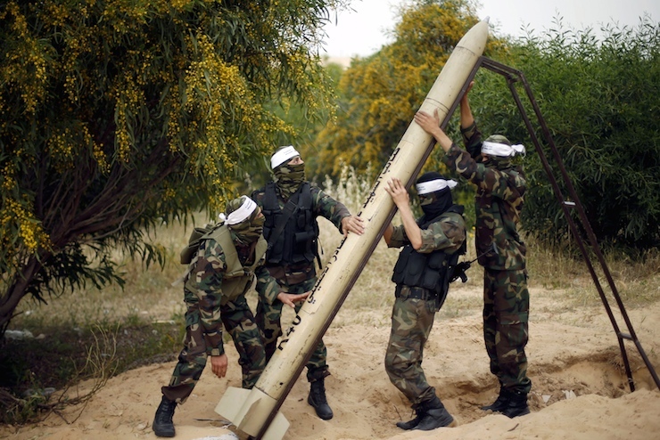 Palestinian militants show a home-made rocket to the media during an anti-Israel joint drill by National Resistance Brigades and Abdel Qader al Husseini Brigades in Khan Younis in the southern Gaza Strip