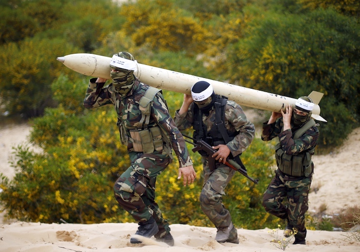 Palestinian militants carry a home-made rocket after an anti-Israel joint drill in Khan Younis in the southern Gaza Strip