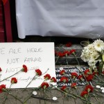 Carnations and a sign are placed at the scene of a suicide bombing at Istiklal street, a major shopping and tourist district, in central Istanbul
