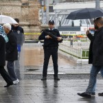 Police officers stand guard at Taksim square after a suicide bombing on a major shopping and tourist district in central Istanbul
