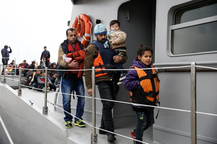 Refugees and migrants prepare to disembark a Greek Coast Guard vessel at the port of Mytilene on the Greek island of Lesbos, following a rescue operation at open sea, March 22, 2016. REUTERS/Alkis Konstantinidis