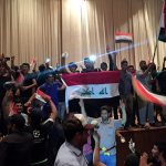 Followers of Iraq's Shi'ite cleric Moqtada al-Sadr are seen in the parliament building as they storm Baghdad's Green Zone after lawmakers failed to convene for a vote on overhauling the government, in Iraq