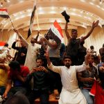 Followers of Iraq's Shi'ite cleric Moqtada al-Sadr are seen in the parliament building after they stormed Baghdad's Green Zone after lawmakers failed to convene for a vote on overhauling the government