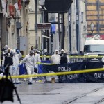Police forensic experts inspect the area after a suicide bombing in a major shopping and tourist district in central Istanbul