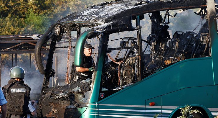 Emergency workers search the scene after a blast on a bus in Jerusalem