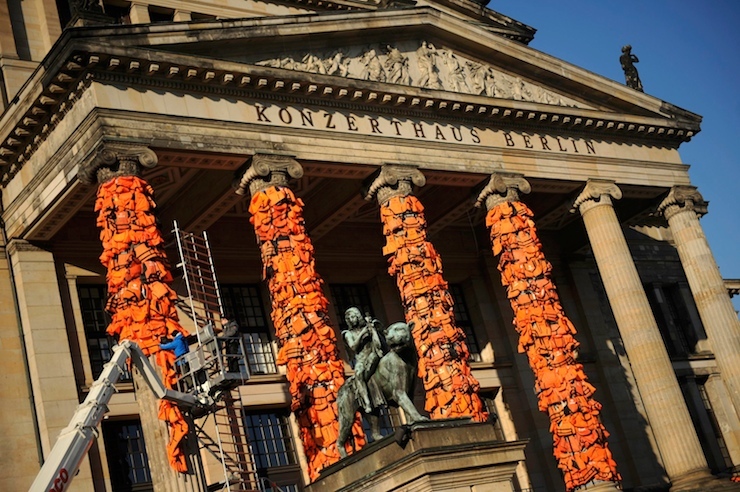Workers bulid up an instalation by Chinese artist and free-speech advocate Ai Weiwei with life jackets left by migrants on Greek beaches on columns at the Schauspielhaus concert hall during the 66th Berlinale International Film Festival in Berlin, Germany February 13, 2016. Ai Weiwei used about 14,000 discarded life jackets, which he obtained from authorities from the Greek island of Lesbos for this memorial project. REUTERS/Stefanie Loos FOR EDITORIAL USE ONLY. NOT FOR SALE FOR MARKETING OR ADVERTISING CAMPAIGNS.