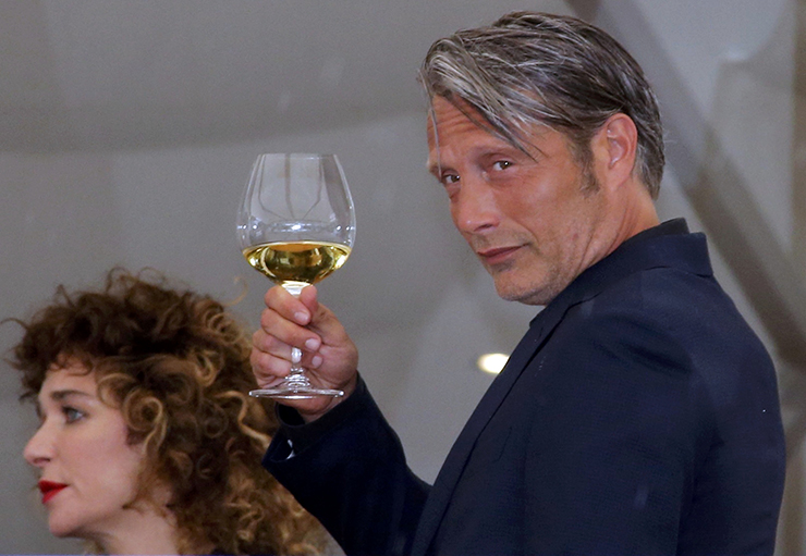 Jury member actor Mads Mikkelsen holds a glass of wine on the terrace at the Grand Hyatt Cannes Hotel Martinez on the eve of the opening of the 69th Cannes Film Festival in Cannes