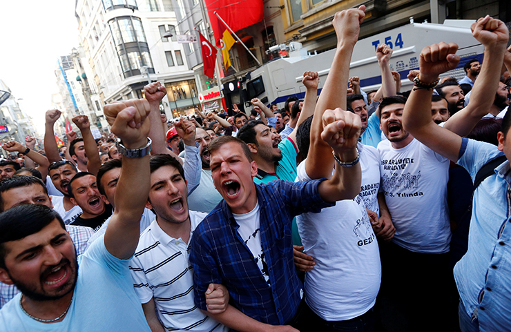Demonstrators shout slogans during a gathering to mark the third anniversary of Gezi Park protests, in central Istanbul
