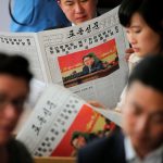 Foreign reporters and their government guides follow, in newspapers and broadcast on television, the address by North Korean leader Kim Jong Un to the Workers' Party of Korea (WPK) congress, at a hotel in central Pyongyang