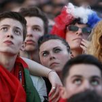 France and Portugal fans react at Paris fan zone during a EURO 2016 final soccer match