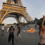 Garbage burns during clashes outside the Paris fan zone during a EURO 2016 final soccer match