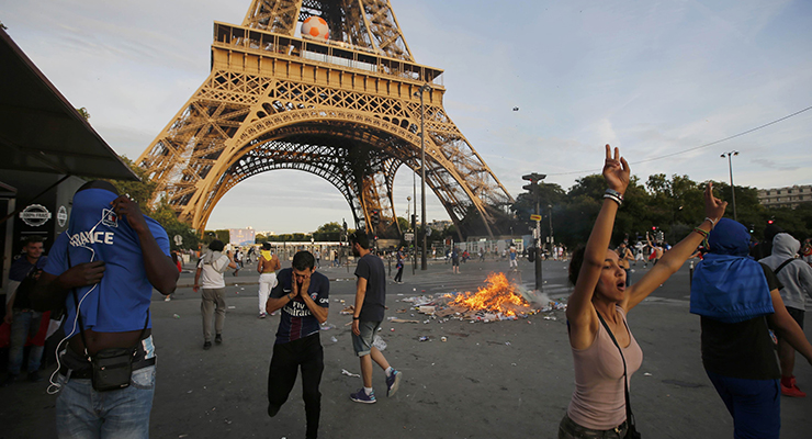 Garbage burns during clashes outside the Paris fan zone during a EURO 2016 final soccer match