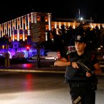 Police officers stand guard near the Turkish military headquarters in Ankara