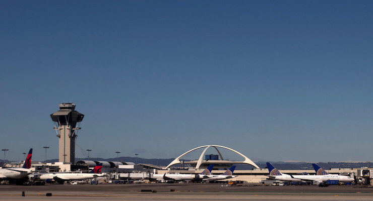 FILE PHOTO - United Airlines planes are seen in the foreground of the Los Angeles International Airport (LAX) and its air traffic control tower on February 20, 2013. Picture taken on February 20, 2013. REUTERS/Adrees Latif/Files