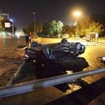 A flipped car lies in a road near military headquarters in Ankara