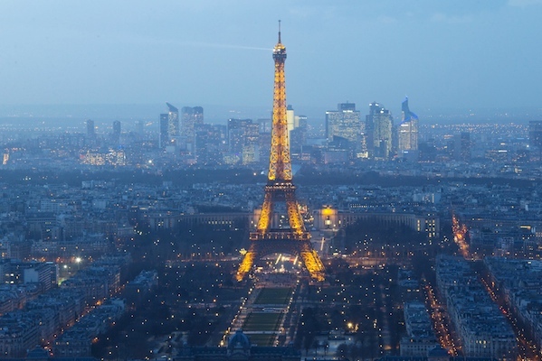 A general view of the Eiffel Tower and La Defense business district (background) in Paris in this February 24, 2015 file photo. Gunmen and bombers attacked busy restaurants, bars and a concert hall at locations around Paris on November 13, 2015 , killing dozens of people in what a shaken President Francois Hollande described as an unprecedented terrorist attack. REUTERS/Gonzalo Fuentes/Files