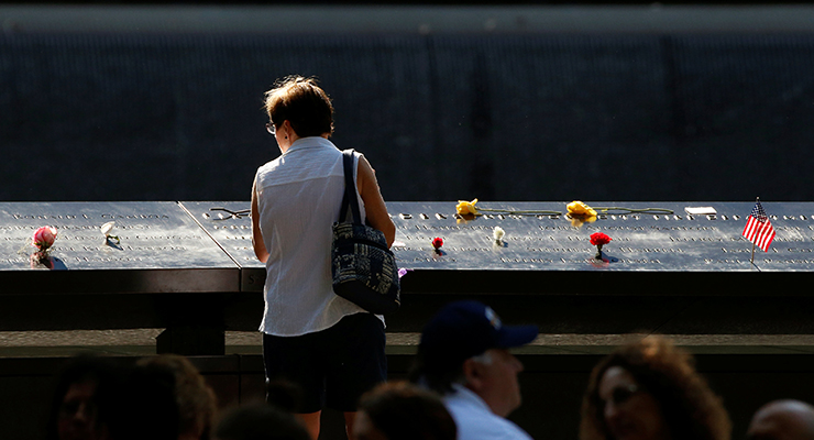 Guests looks at the memorial during the ceremony marking the 15th anniversary of the attacks on the World Trade Center at The National September 11 Memorial and Museum in New York