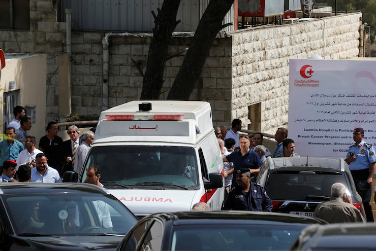 An ambulance transports the body of Jordanian writer Nahed Hattar to a medical facility, after he was shot, in Amman, Jordan, September 25, 2016. REUTERS/Muhammad Hamed