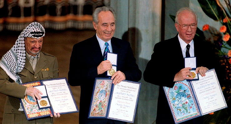 File photo of PLO Chairman Yasser Arafat, Israeli Foreign Minister Shimon Peres and Israeli Prime Minister Yitzhak Rabin showing their shared Nobel Peace Prize in Oslo