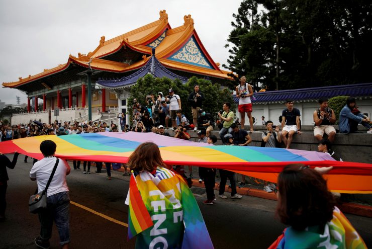 Participants hold a giant rainbow flag as they take part in the lesbian, gay, bisexual and transgender (LGBT) pride parade in Taipei