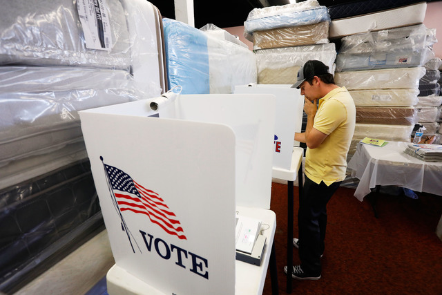 A man votes during the 2016 presidential election at Mattress Warehouse in Hawthorne, California