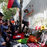 People gather after the announcement of the death of Cuban revolutionary leader Fidel Castro outside the Cuban embassy in Chile