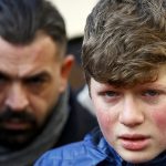 Boy cries at the funeral of Arik, a victim of an attack by a gunman at Reina nightclub, in Istanbul